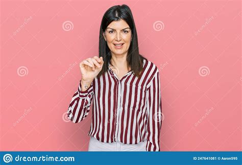 Beautiful Brunette Woman Wearing Striped Shirt Showing And Pointing Up