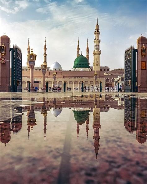 An Image Of A Mosque In The Middle Of The Day With Its Reflection On