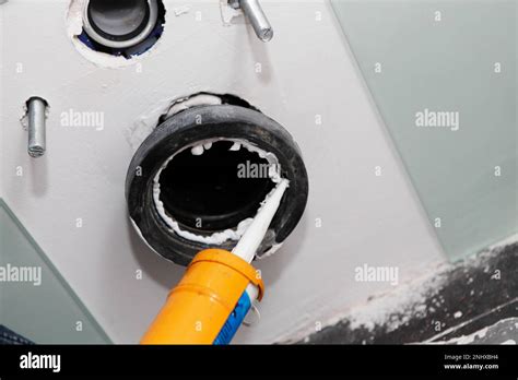 Caulking a closet flange, toilet flange of a wall mounted toilet. Toilet flange installation by ...