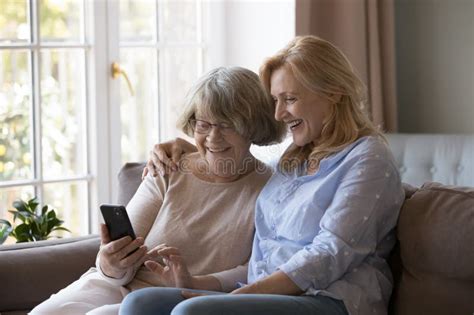 Happy Mature Woman Hugging Cheerful Old Mom Using Smartphone Stock Photo Image Of Love