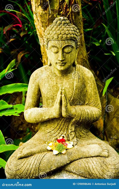 Stone Statue Of Buddha Sitting Praying And Meditating For Mind Body