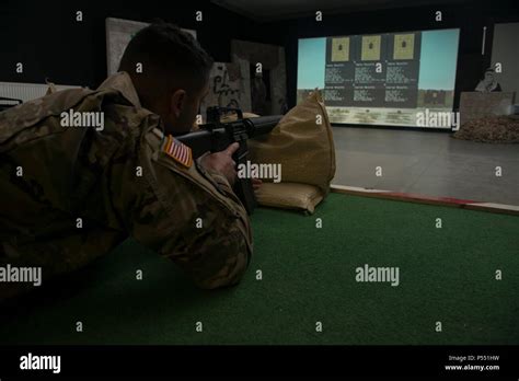 U.S. Soldiers train using the Engagement Skills Trainer II, EST II, at ...