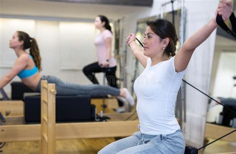 Joven Latina Practicando Pilates En Reformador En El Gimnasio Foto De Archivo Imagen De