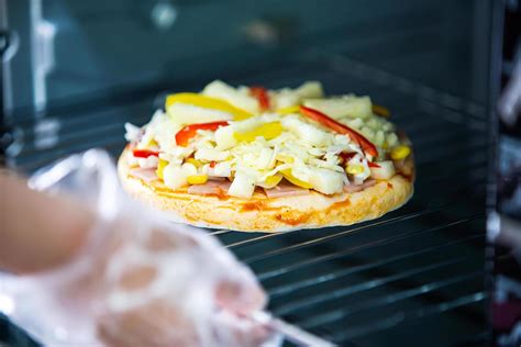 Cooking homemade pizza using oven at home 7189924 Stock Photo at Vecteezy