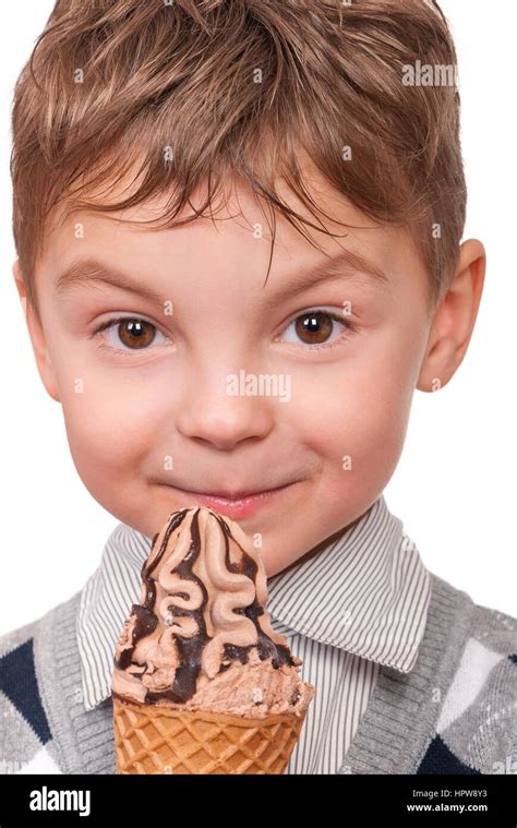 Portrait of cheerful little boy with ice cream cone. Close-up of child eating ice-cream with ...