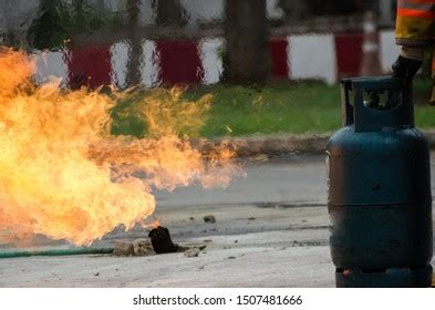 Man Using Fire Extinguisher Fighting Fire Stock Photo