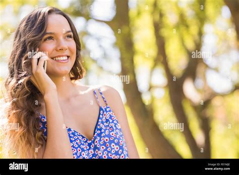 Pretty Brunette Having Phone Call In The Park Stock Photo Alamy