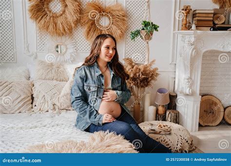 Pregnant Woman In Denim Jacket With Naked Tummy Sitting In Bed Stock Photo Image Of Care Love