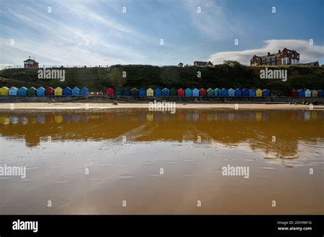 Mundesley Beach With Beach Huts And Clifftop With Houses Seen From The