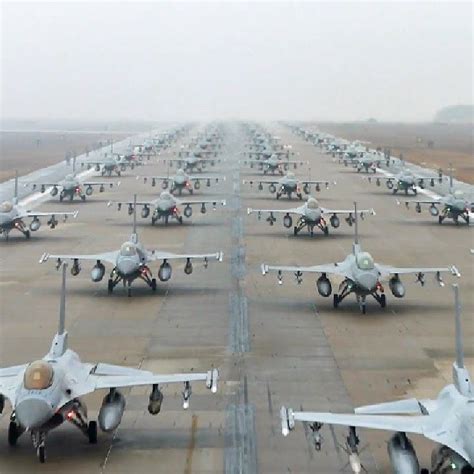 Several Fighter Jets Lined Up On The Tarmac At An Air Port With Fog In