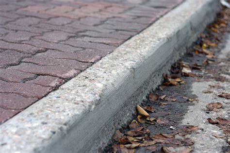 Curb A Concrete Border Or Row Of Joined Stones Forming Part Of A