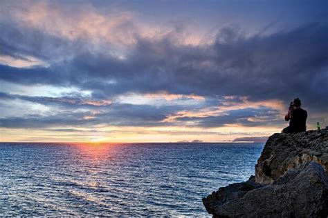 Premium Photo Young Man Watching The Sunset On The Barbate Beach Next