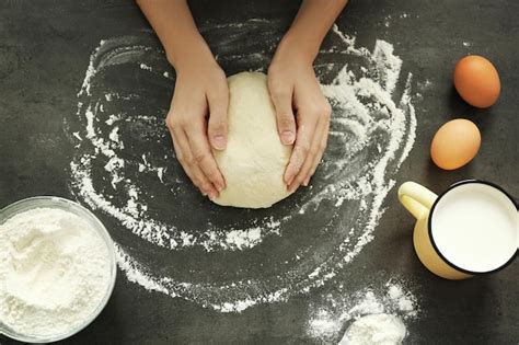 Premium Photo Female Hands Kneading Dough On Table Top View