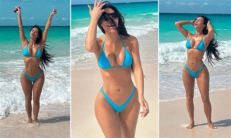 Kardashian Flaunts Her Curves As She Strips Down To A Tiny Blue Bikini