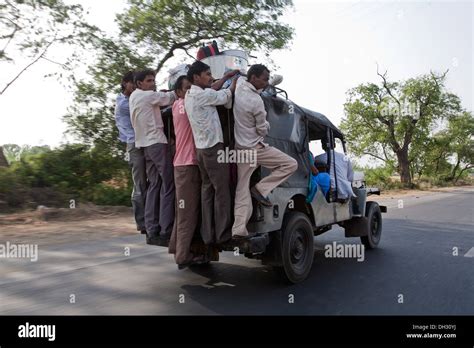 People Crowded On A Jeep Taxi Running On The Road Near New Delhi India