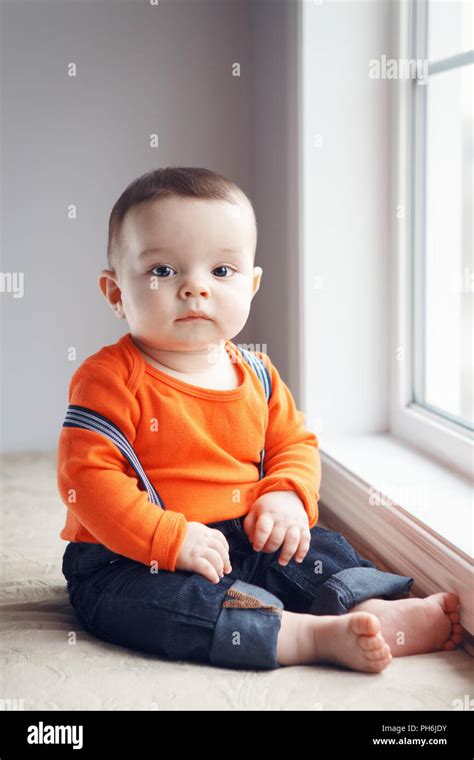 Portrait of cute adorable stylish Caucasian baby boy with black eyes in ...