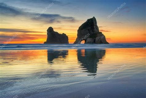 Sunset at Wharariki Beach, New Zealand — Stock Photo © mktree7 #98949224