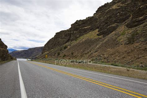 View of highway road through mountains — daylight, remote - Stock Photo | #182381570