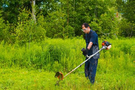 Man Mowing Grass With A Lawn Mower Stock Image Image Of Garden Park