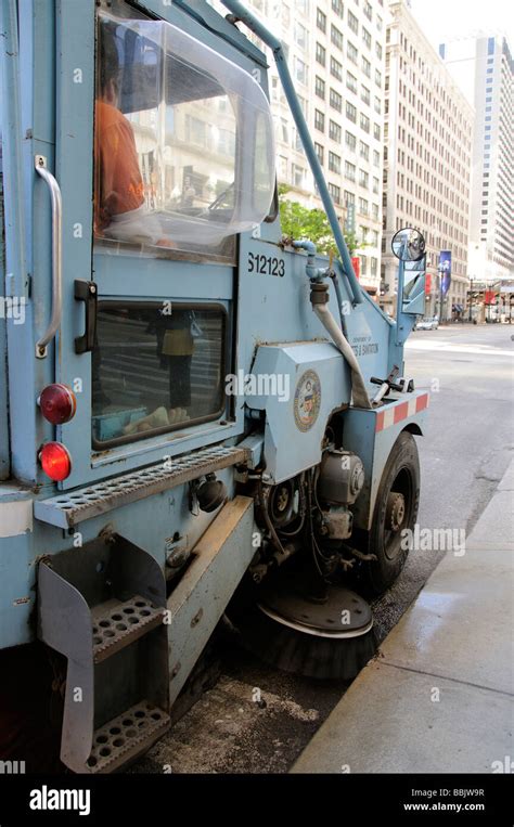 Mechanical Road Sweeper Machine Sweeping The Gutters Of Sate Street