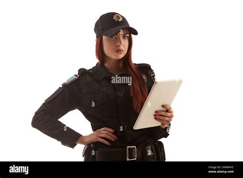 Redheaded Female Police Officer Is Posing For The Camera Isolated On