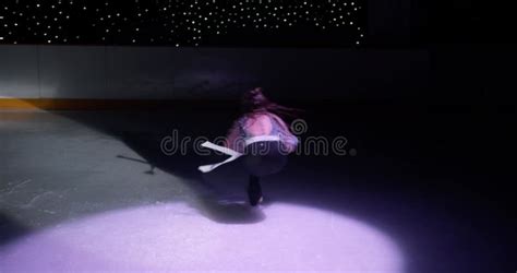 Amazing Solo Act Of Gorgeous Ice Skater Girl In White Dress On Empty Dark Ice Rink In Spotlight