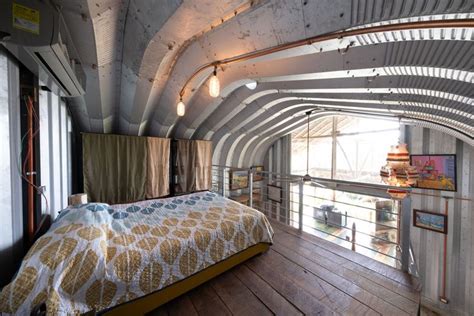 a bedroom with wooden floors and exposed ceilings