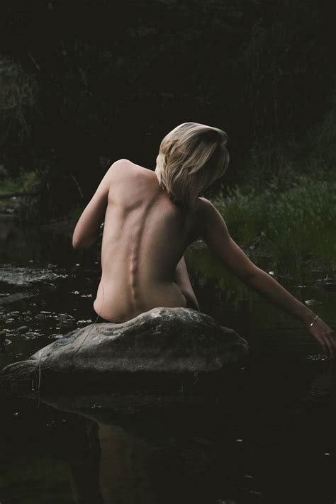 Free Photo Back View Of Nude Woman Sitting On The Rock