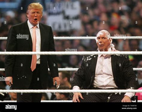 Donald Trump (L) mocks Vince McMahon after shaving his head following ...