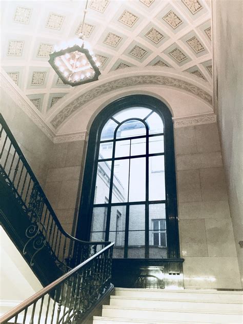 the stairs lead up to an arched window