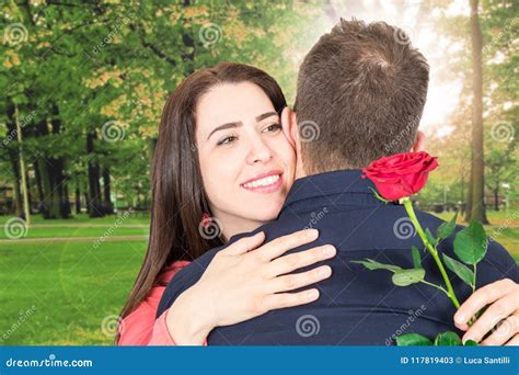 Happy Woman Hugs Her Love Holding A Rose In A Park Stock Image Image