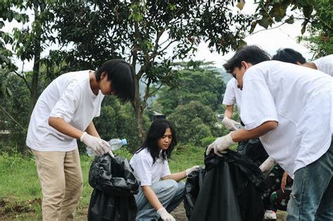 Premium Photo Group Of People Picking Up Trash In The Park Volunteer