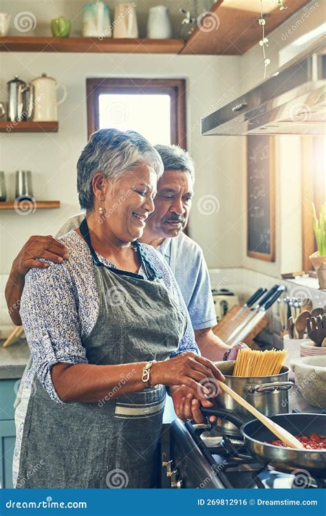 Cooking Is An Expression Of Love A Happy Mature Couple Cooking A Meal Together At Home Stock