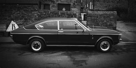 Premium Photo Vintage Car Parked On Road By Old Building