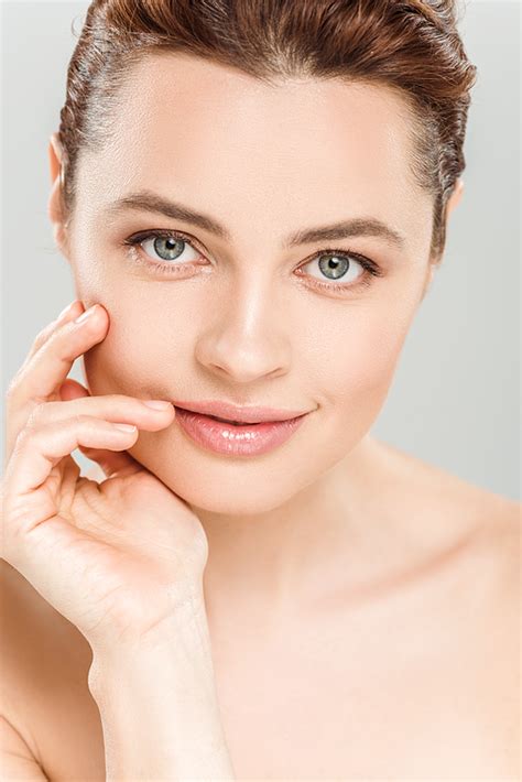 Cheerful Naked Woman And Touching Face Isolated On Grey