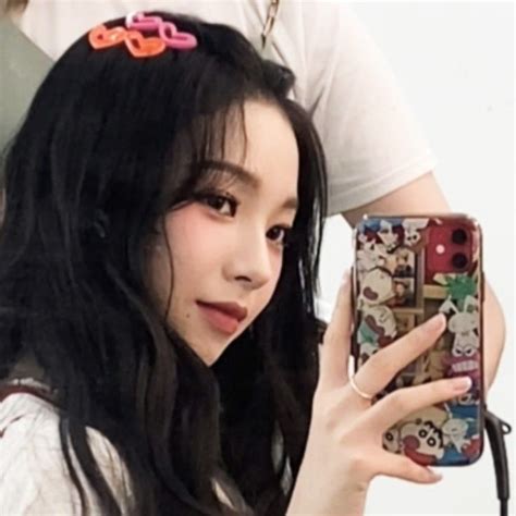 A Girl With Long Black Hair Holding Up Her Cell Phone