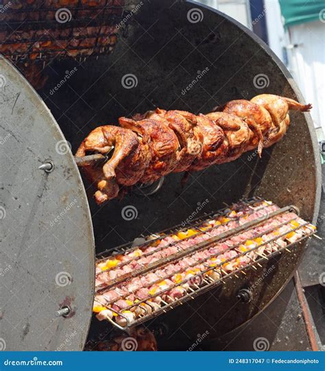 Industrial Rotisserie with Spit-roasted Chickens and Skewers of Stock