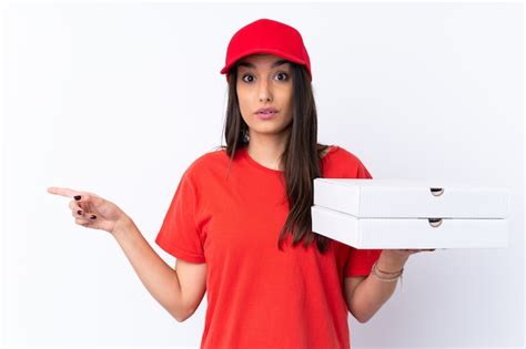 Premium Photo Pizza Delivery Woman Holding A Pizza Over Isolated White Wall Surprised And