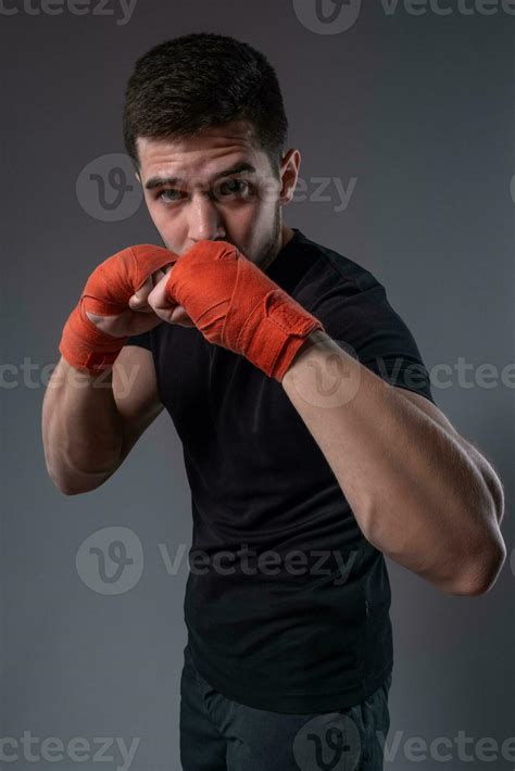 Concentrated Fighter With Wrist Wraps Standing In Orthodox Stance