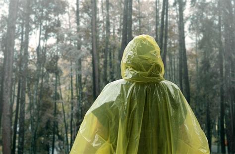 Premium Photo Rear View Of Woman Wearing Raincoat Against Trees In Forest