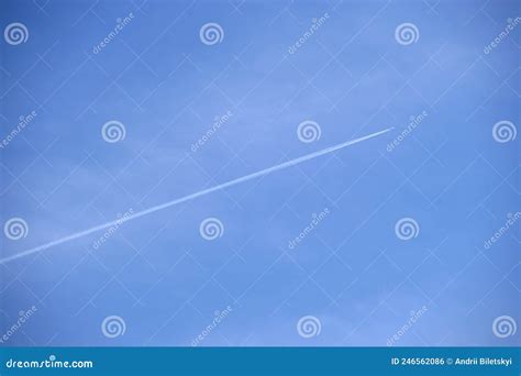 Distant Passenger Jet Plane Flying On High Altitude On Clear Blue Sky