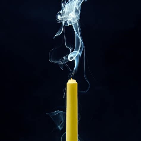 Premium Photo Smoke From An Extinguished Candle On A Dark Background