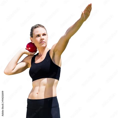 Sportswoman practicing the shot put Stock Photo | Adobe Stock