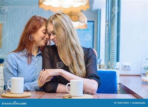 Same Sex Relationships Happy Lesbian Couple Sitting In A Cafe Girls