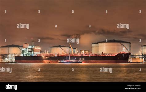 Night Scene With Moored Tanker At Embankment Of Illuminated