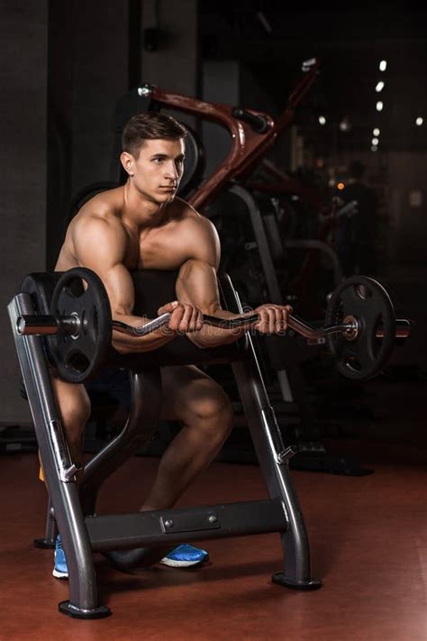 Muscular Man Working Out In Gym Doing Exercises With Barbell Stock Image Image Of Fitness