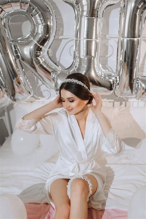 Brunette Bride In A White Robe And Veil Sitting On The Bed Posing Diadem Stock Photo Image