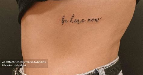 "Be here now" lettering tattoo placed on the rib.