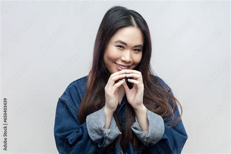 Portrait Of Mysterious Brunette Woman In Blue Denim Jacket Has Interesting Plan In Mind