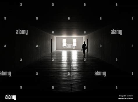 Silhouette Of Person Walking In Dark Corridor Stock Photo Alamy